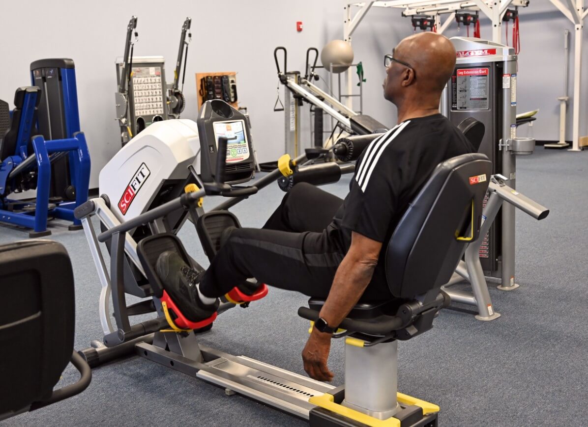 Patient working out on a strength machine